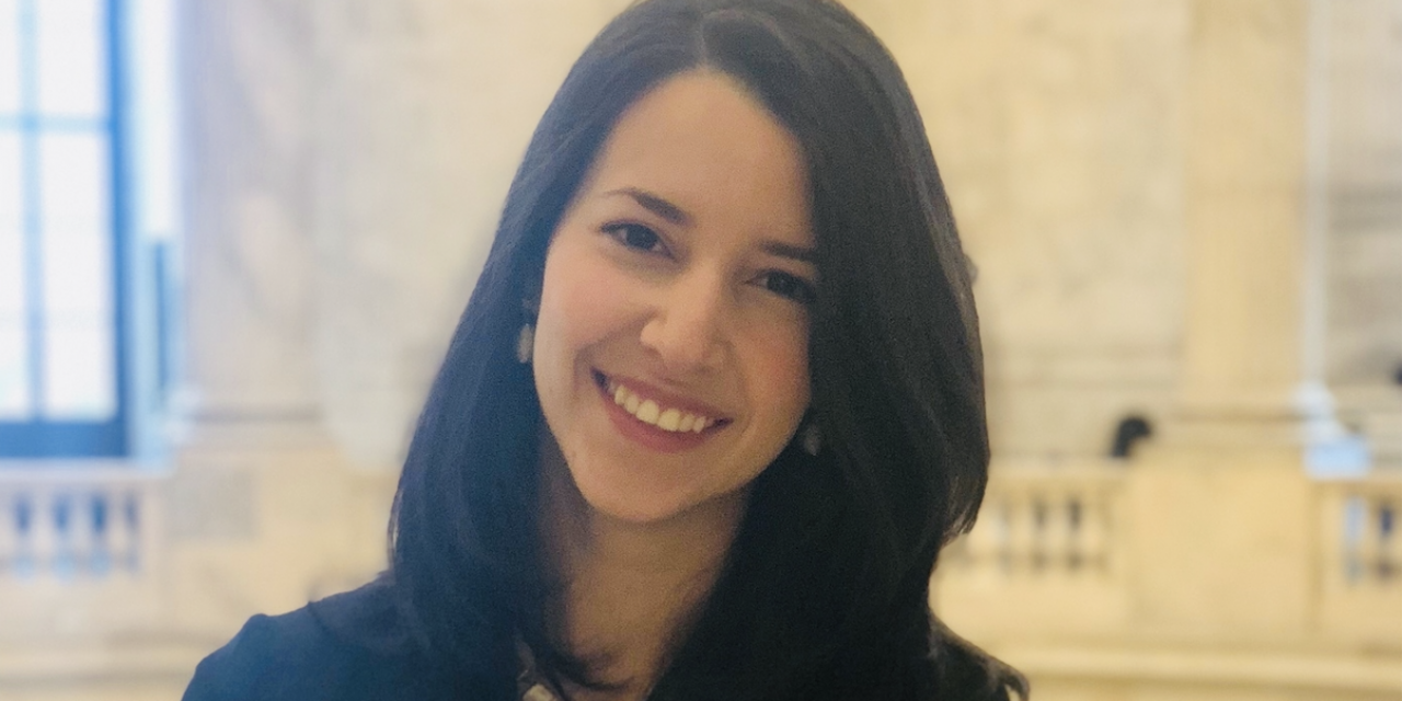 A smiling woman with brown hair.