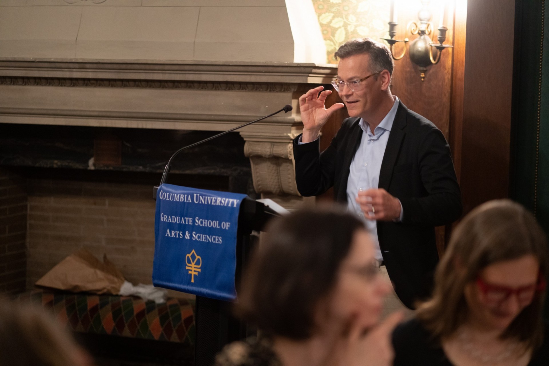 Man at lectern, giving a speech