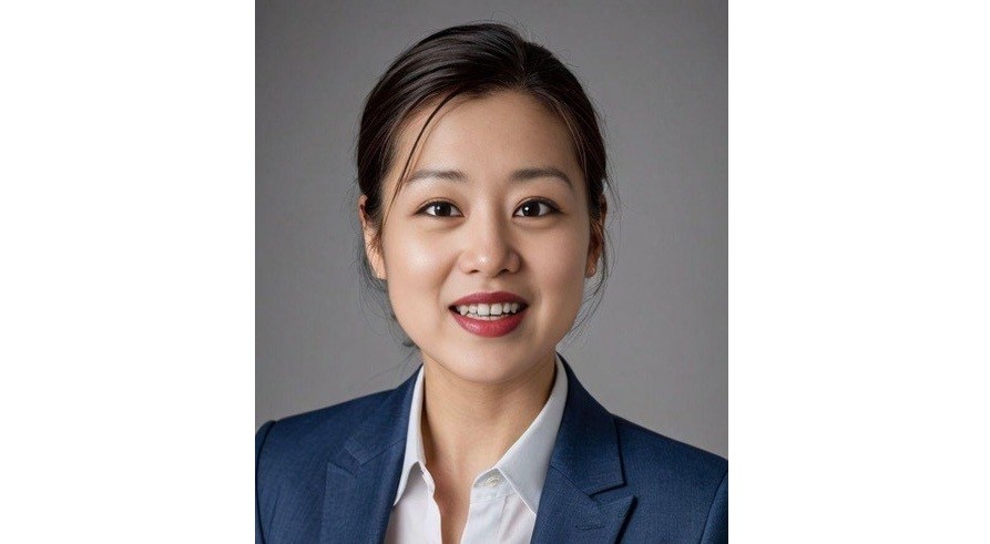 Woman in a suit smiling.
