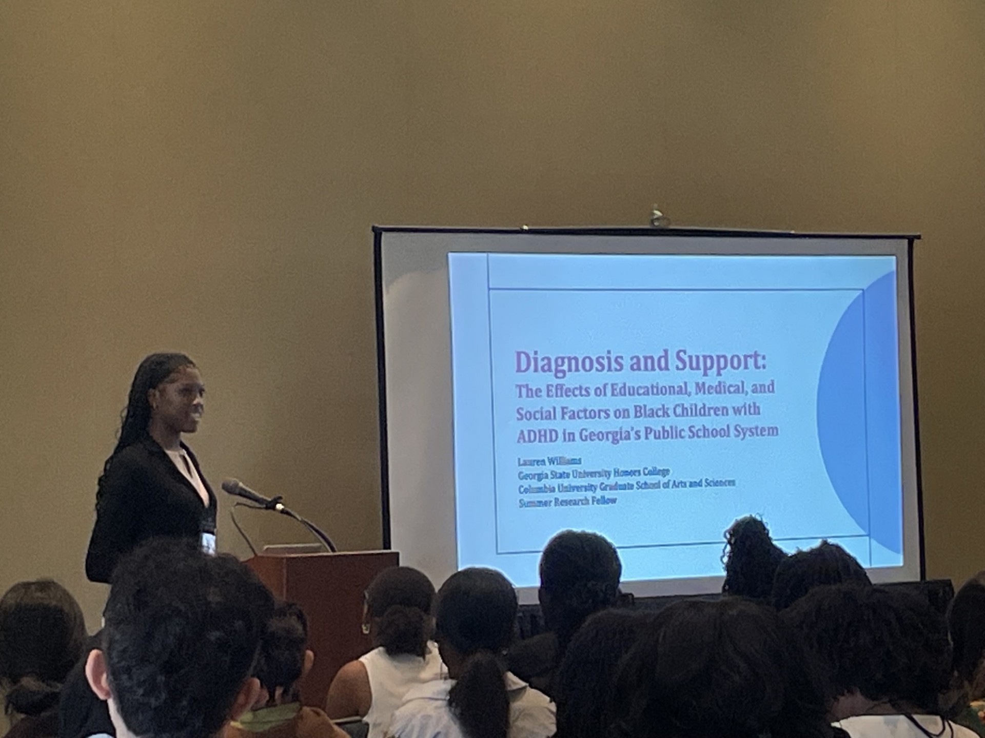 Lauren Williams presents her research at the Leadership Alliance National Symposium in Hartford, CT. Woman presenting slides of her research