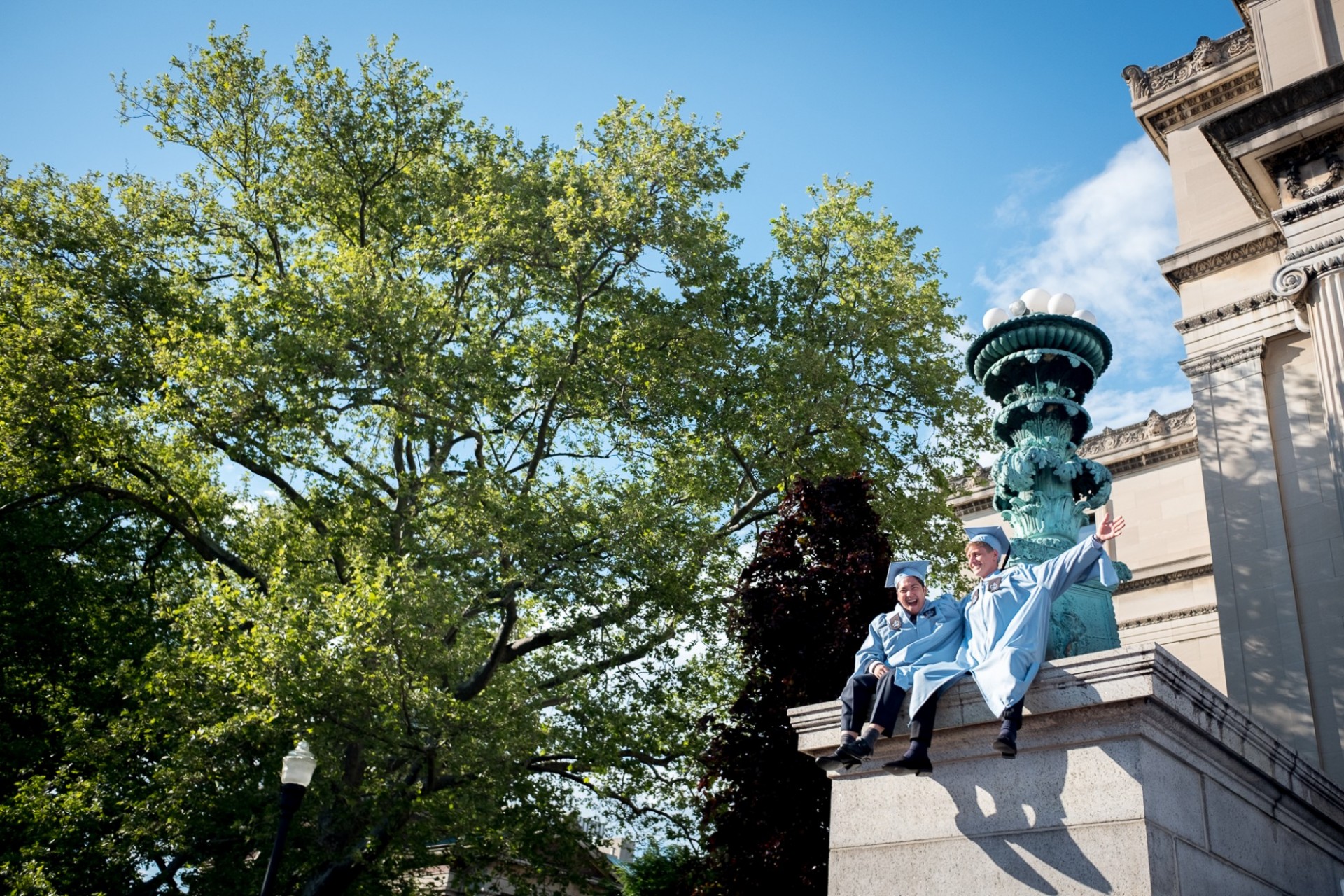 MA graduates celebrate on the steps of Low Library.