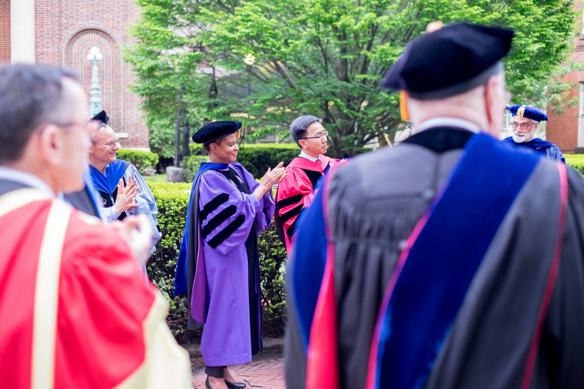 Alondra Nelson—professor of sociology, dean of social science, and keynote speaker for the PhD ceremony—applauds graduates.