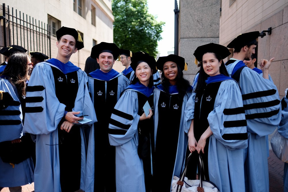 PhD candidates arrive for the ceremony on Broadway and 114th Street.