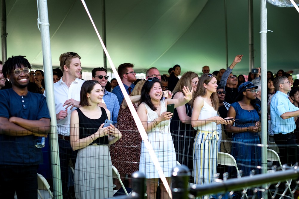 Family and friends cheer as the MA graduates take their seats. Family and friends cheer as the MA graduates take their seats.