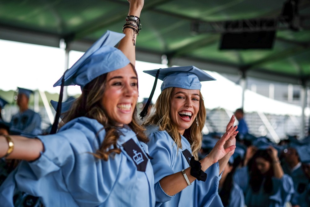 MA graduates celebrate after crossing the stage.