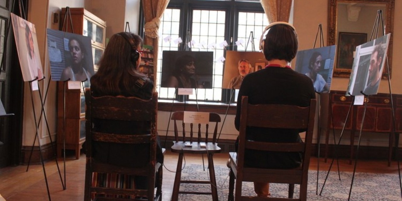 two people facing pictures on easels