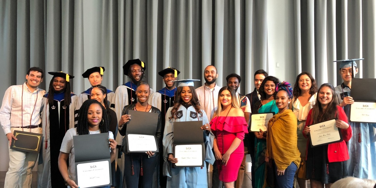 Group of students hold up awards