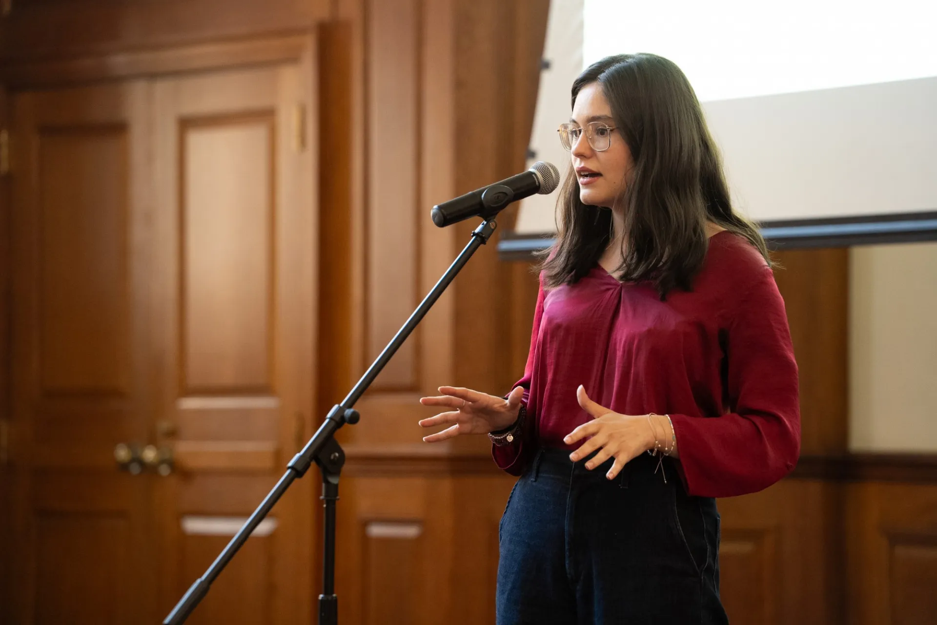 A woman speaking into a microphone.