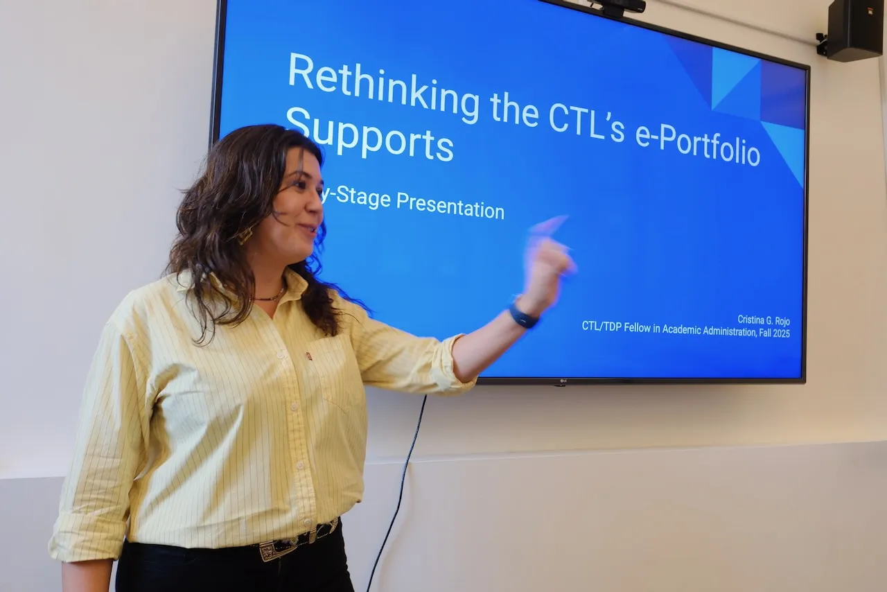 Student pointing at screen giving a presentation