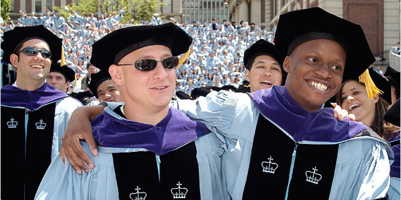 graduates hugging each other