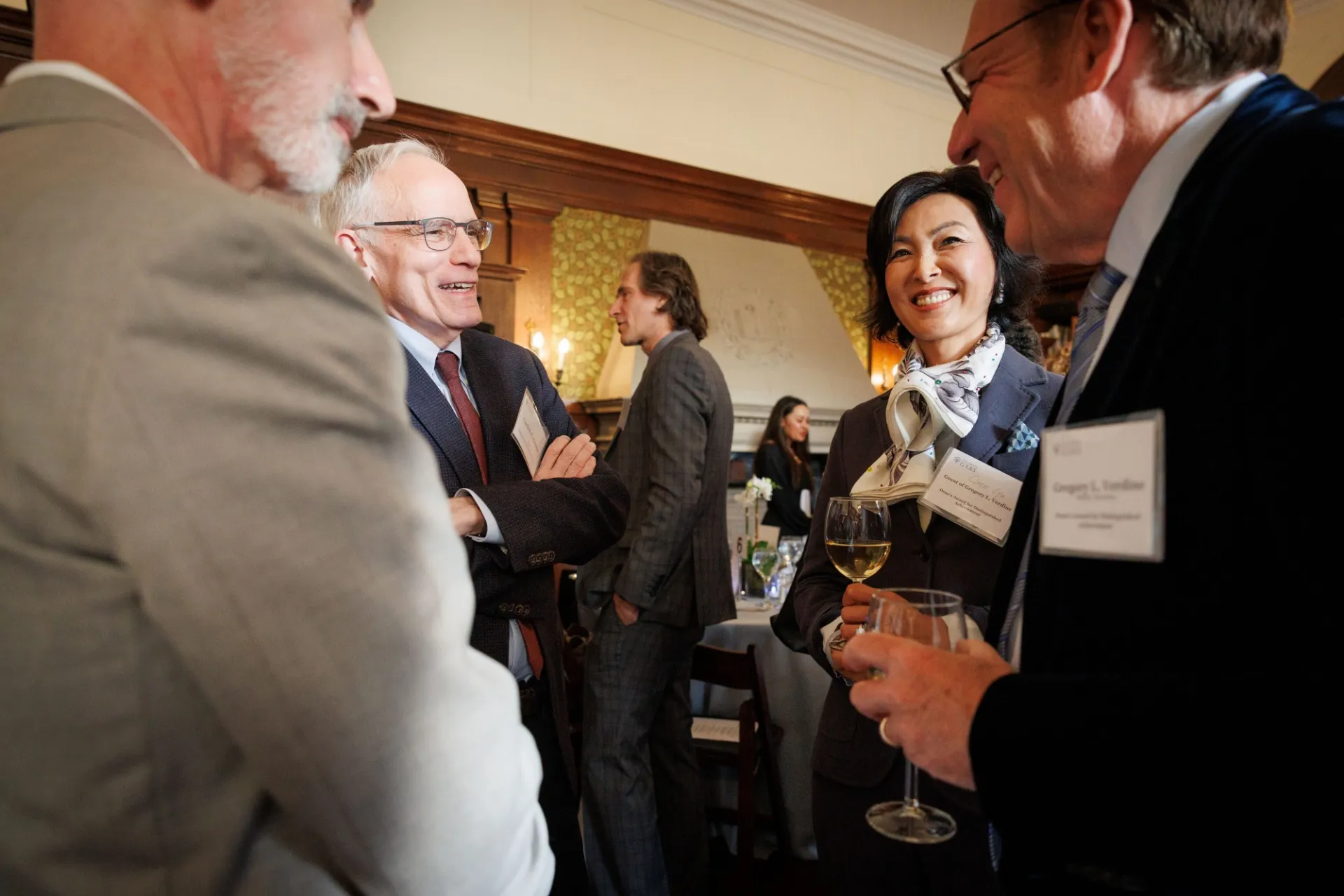 A group of people chatting and smiling.