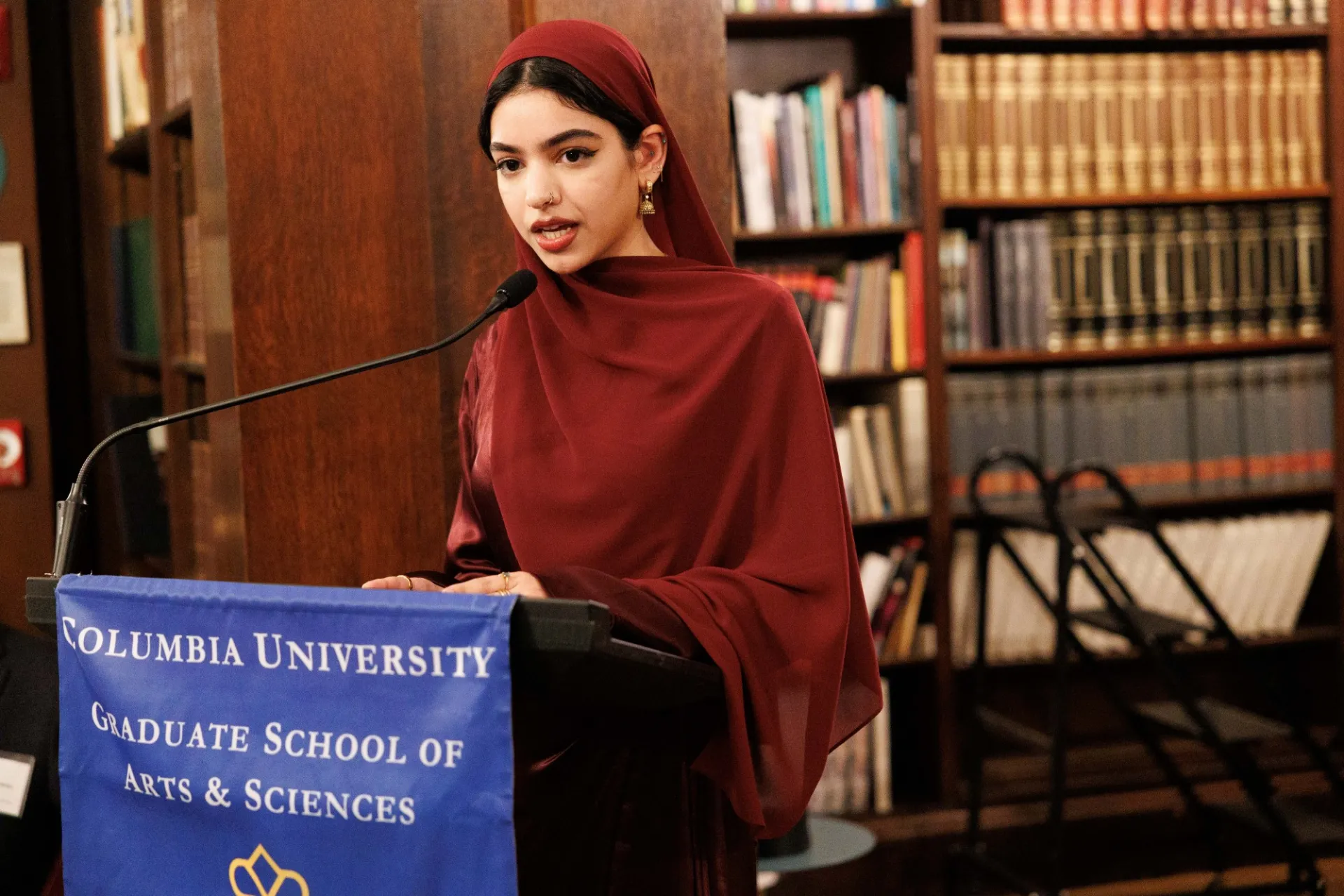 A woman speaking at a lectern.