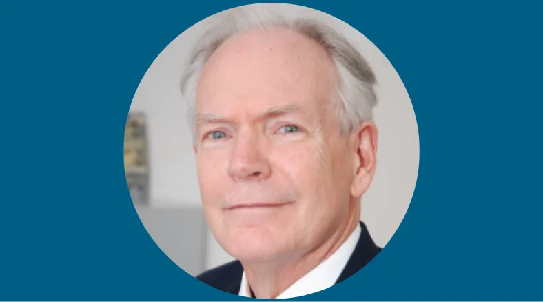 A man with gray hair in a suit.