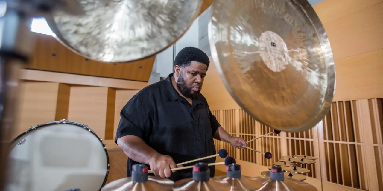 A man sits at a drumset.