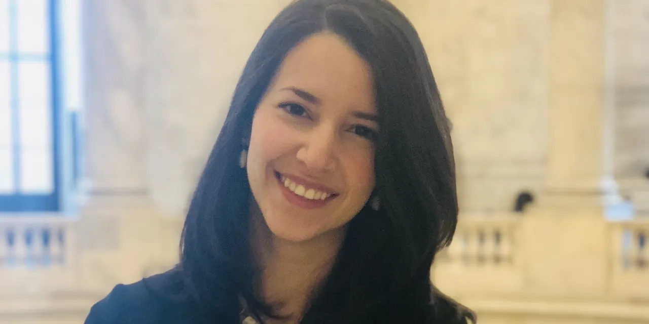 A smiling woman with brown hair.