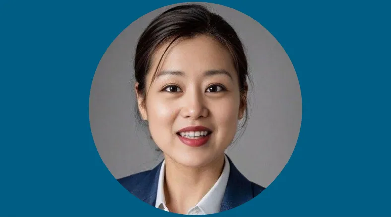 A portrait of a smiling woman in a suit.