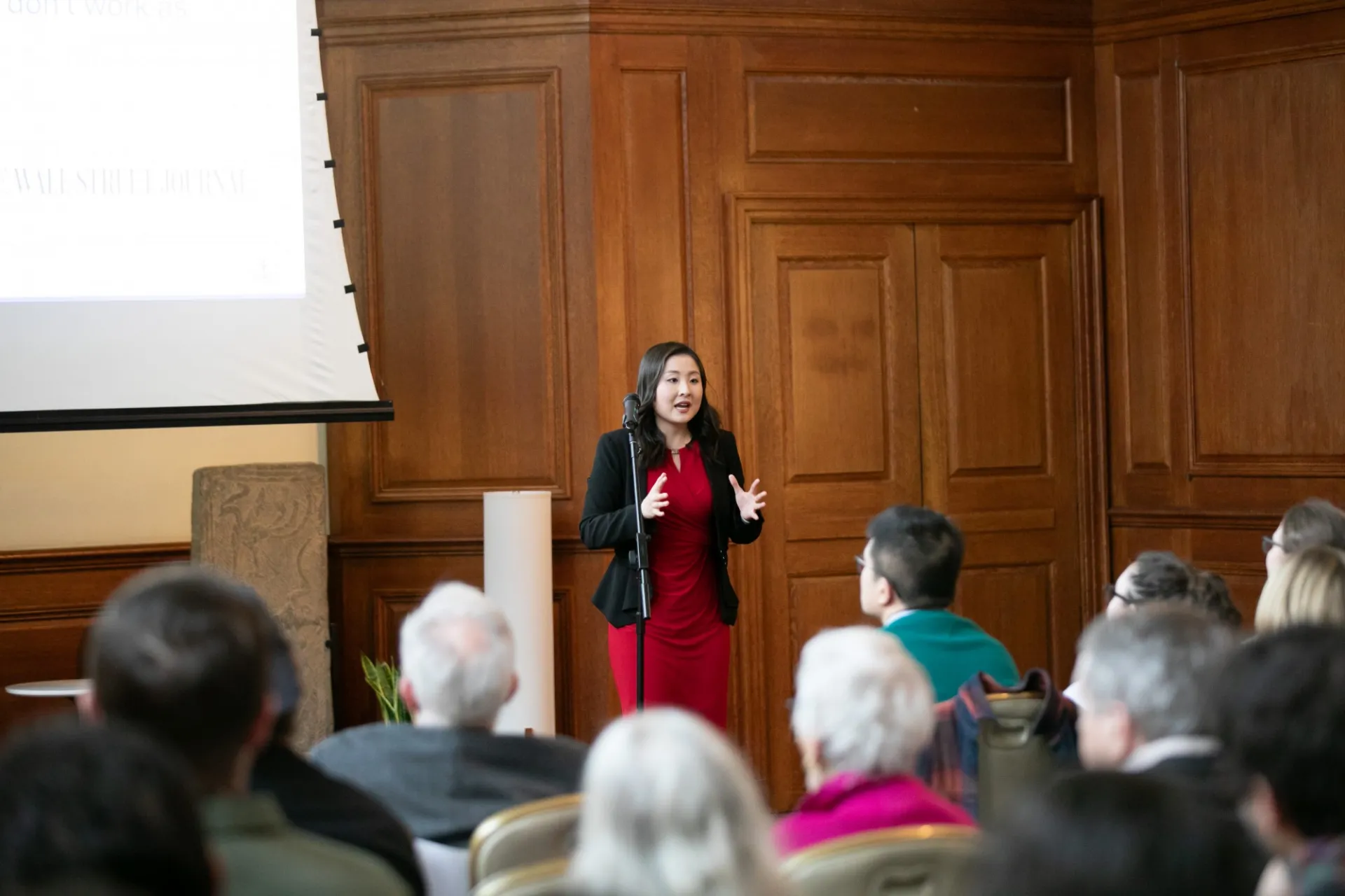 Female student standing giving a speech to audience